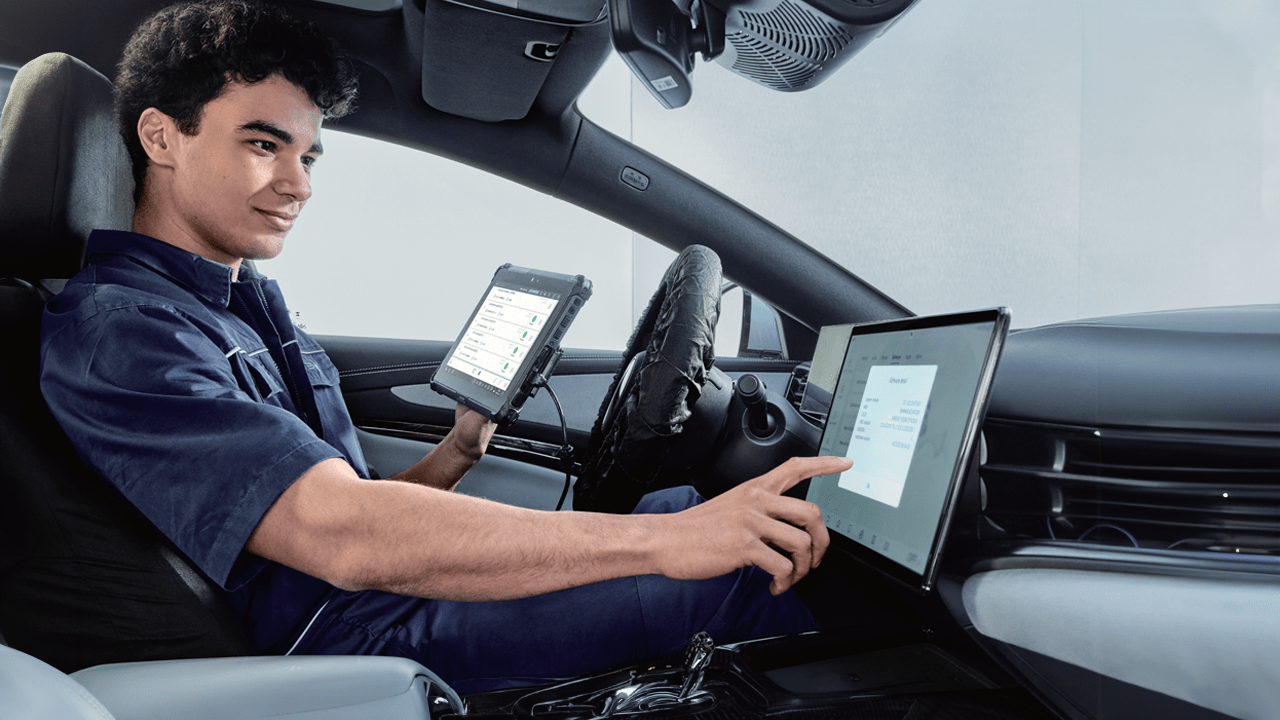 Mécanicien BYD tenant une tablette digitale pour entretien des véhicules BYD